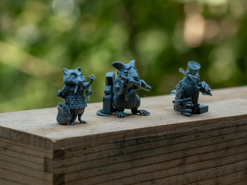 All three minis lined up on a wooden beam