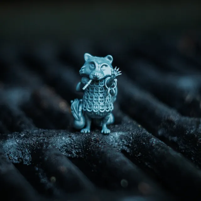 The Raccoon mini on a rusted grill